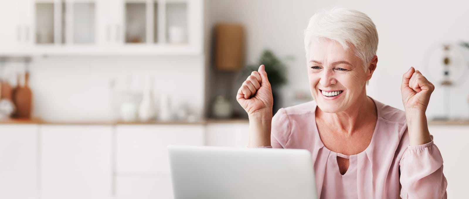 61472634_happy-senior-woman-celebrating-success-in-front-of-laptop